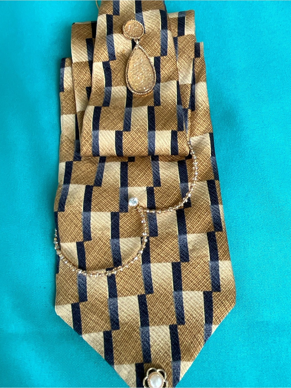 Subtle: a Gold and Navy silk tie necklace with gold and rhinestone accents